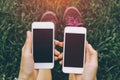 Close up of young asian healthy women`s hands holding two cell telephone with blank copy space. Royalty Free Stock Photo