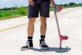 Close Up A young Asian man`s legs are skateboarding on a country road on a sunny and clear day., Play surf skate