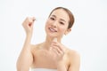 Close-up young Asian woman applying serum on her face. Clean soft make up and isolated white background