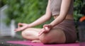 Close up, Young Asian woman doing yoga, meditation on a calm yoga mat in a green park in the early morning. Young woman Royalty Free Stock Photo