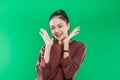 close up young Asian woman expressing wide-open mouth and raising hands in amazement