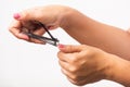 Woman cutting nails on finger using a nail clipper Royalty Free Stock Photo