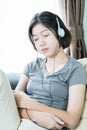 Young woman listening music from mobile phone