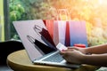 Close up ,Young asian woman typing laptop keyboard and holding credit card at coffee shop with online shopping or internet banking Royalty Free Stock Photo