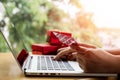 Close up ,Young asian woman typing laptop keyboard and holding credit card at coffee shop with online shopping or internet banking Royalty Free Stock Photo