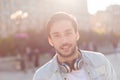 Close up of a young attractive brunete guy, walking in the city