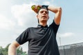 Close up of young man relaxing after tournament and holding tennis balls. Royalty Free Stock Photo