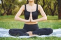 Close up of young attractive woman doing yoga in lotus position in the park Royalty Free Stock Photo