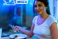 Close up of young attractive woman eating asian food with chopsticks at cafe. Royalty Free Stock Photo