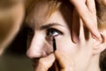 Close up of Young beautiful bride applying make-up by make-up artist Royalty Free Stock Photo