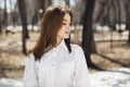 Young beautiful brunette girl in white shirt posing on spring park Royalty Free Stock Photo