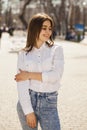 Young beautiful brunette girl in white shirt posing on spring park Royalty Free Stock Photo