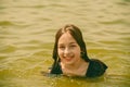 A girl swims in the river. Close up of young beautiful girl in water Royalty Free Stock Photo