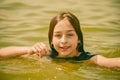 A girl swims in the river. Close up of young beautiful girl in water Royalty Free Stock Photo