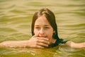 A girl swims in the river. Close up of young beautiful girl in water Royalty Free Stock Photo