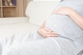 Close up young beautiful pregnant woman hand touching her belly Royalty Free Stock Photo