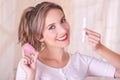 Close up of young beautiful smiling woman holding a menstruation cotton tampon in one hand and with her other hand a Royalty Free Stock Photo