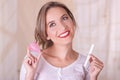 Close up of young beautiful smiling woman holding a menstruation cotton tampon in one hand and with her other hand a Royalty Free Stock Photo