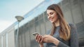 Close-up Of A Young Beautiful Sports Fitness Girl Holding A Smartphone In The Hands, Using A Fitness App. Modern City Royalty Free Stock Photo