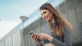 Close-up Of A Young Beautiful Sports Fitness Girl Holding A Smartphone In The Hands, Using A Fitness App. Modern City Royalty Free Stock Photo