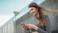 Close-up Of A Young Beautiful Sports Fitness Girl Holding A Smartphone In The Hands, Using A Fitness App. Modern City Royalty Free Stock Photo