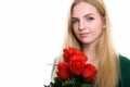 Close up of young beautiful teenage girl holding red roses ready Royalty Free Stock Photo