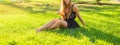 Close-up of young beautiful woman enjoying music outdoors on a grass Royalty Free Stock Photo