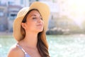 Close up young beautiful woman with hat enjoying sun on the beach. Relaxing sunbathing holidays in Cefalu, Sicily Royalty Free Stock Photo