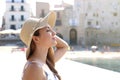 Close up young beautiful woman with hat enjoying sun on the beach. Relaxing sunbathing holidays in Cefalu, Sicily Royalty Free Stock Photo