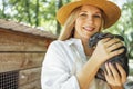 Close up of a young beautiful woman holding a small black rabbit Royalty Free Stock Photo