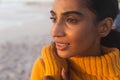 Close-up of young biracial woman thinking while looking away at beach during sunset Royalty Free Stock Photo
