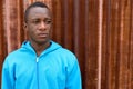 Close up of young black African man thinking against old rusty s Royalty Free Stock Photo