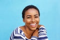 Close up young black fashion woman smiling against blue wall Royalty Free Stock Photo