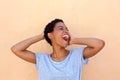Close up young black woman laughing with hands behind head Royalty Free Stock Photo