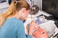 Close Up of Young Blond Woman Painting Clay Mask Royalty Free Stock Photo