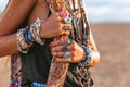 Close up of young boho style woman hands with lots of accessories