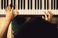 Close up of young boy hands, playing piano. vintage tone filter Royalty Free Stock Photo