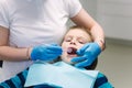 Close up of young boy sitting on the dental chair at the office. Children`s dentist examination baby teeth