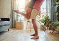Close up of young boyfriend in shorts lifting girlfriend up in modern apartment. Romantic young couple hugging in living Royalty Free Stock Photo
