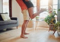 Close up of young boyfriend in shorts lifting girlfriend up in modern apartment. Romantic young couple hugging in living Royalty Free Stock Photo