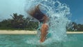 CLOSE UP: Young brunette woman whips her hair back out of the glassy ocean.