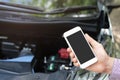 Close up young business man hand using a mobile smart phone call a car mechanic ask for help assistance because car broken on the Royalty Free Stock Photo