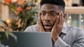 Close-up young businessman looking at laptop screen getting bad news surprised shocked man holding head found error Royalty Free Stock Photo