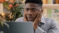 Close-up young businessman looking at laptop screen getting bad news surprised shocked man holding head found error Royalty Free Stock Photo