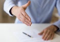 Close up young businessman reaching out hand for shaking. Royalty Free Stock Photo