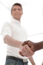 Close up. young businessman shaking hands with business partner Royalty Free Stock Photo