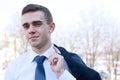 Close up.young businessman standing in modern city