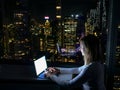 CLOSE UP: Young businesswoman working on her laptop in New York late at night. Royalty Free Stock Photo