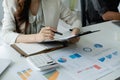 Close up young casual business accountant bookkeeper in office looking at and working with laptop and income tax return Royalty Free Stock Photo