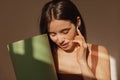 Close-up young caucasian girl listening to relaxing music with eyes closed and holding rolled mat. Royalty Free Stock Photo